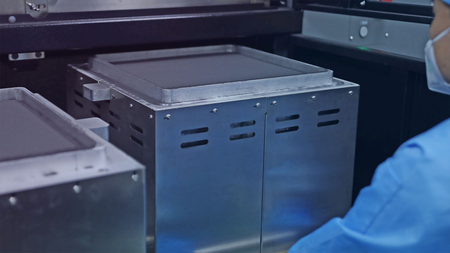 Removing newly formed 3d printing insole parts from the SLS printer's powder bed cake, revealing the raw batch production